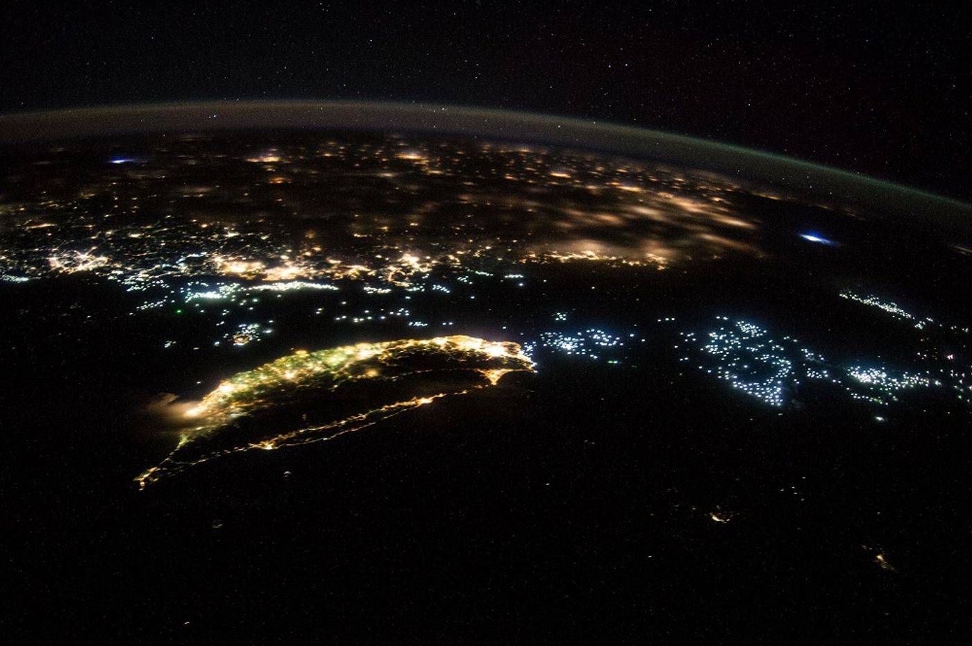 Hundreds of fishing vessels (blue lights) ply the waters between Taiwan (center foreground) and China. Image courtesy of NASA Johnson/Flickr