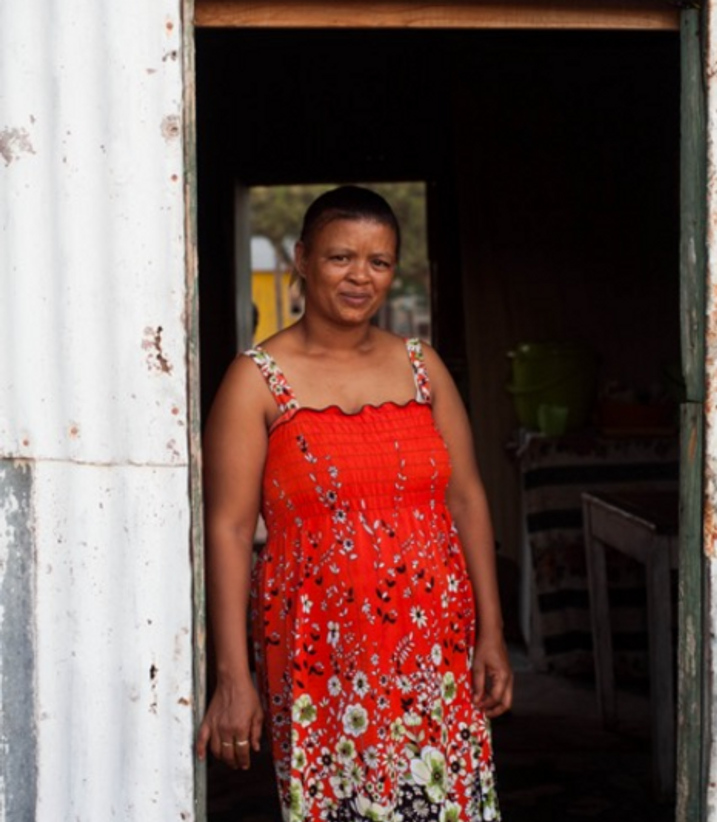 Nama woman standing in the doorway to her home in Kuboes, South Africa, a UNESCO World Heritage Site. Credit: Justin Myrick-Tarrant