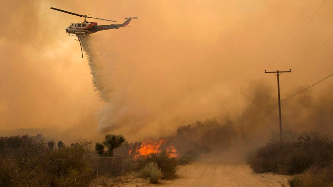 A helicopter makes a water drop at the Blue Cut wildfire. Photo: Jonathan Alcorn/ AFP/Getty Images