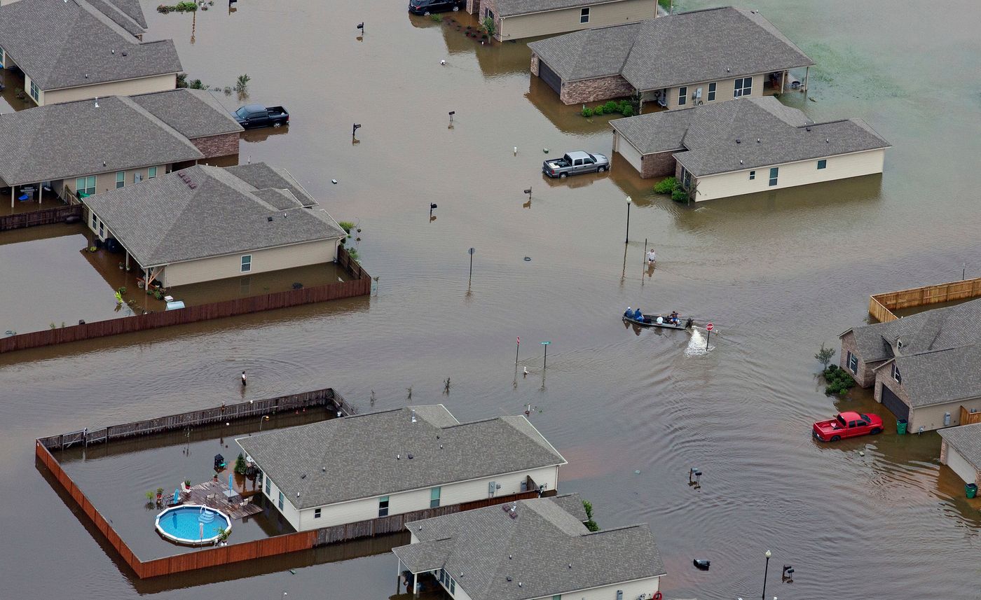 Boats motored along flooded streets in Hammond, La., on Saturday. Credit Max Becherer/FR 171354AP, via Associated Press..