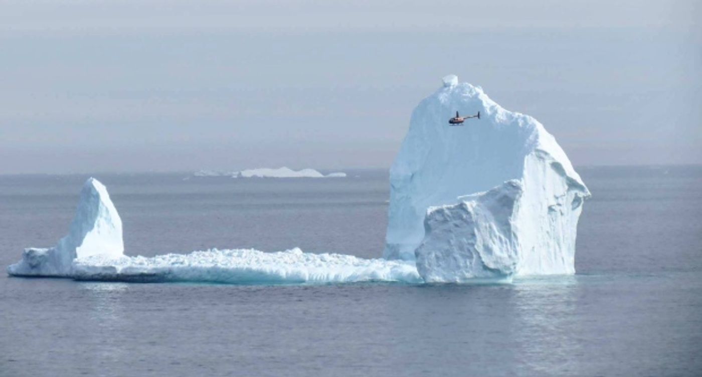 A helicopter flying by shows the impressive size of the iceberg. Photo: CBC