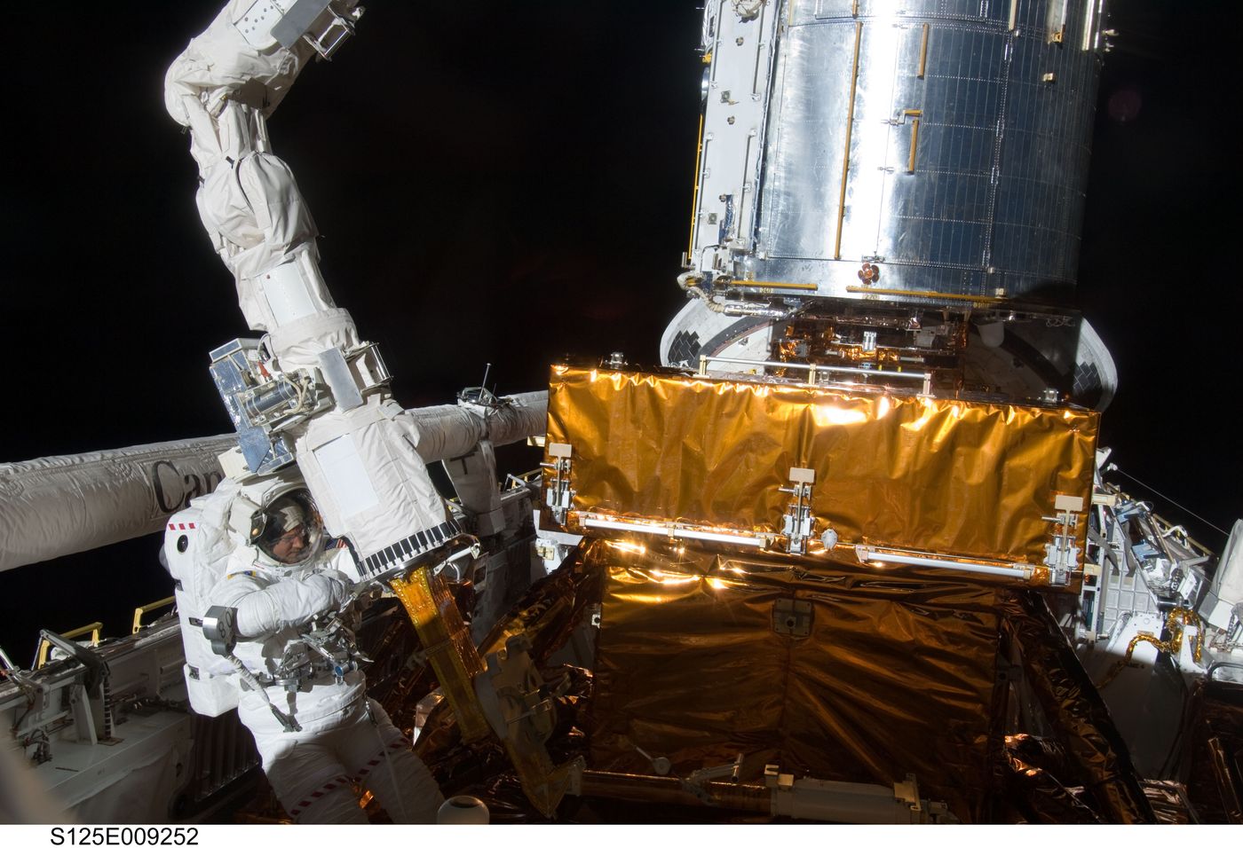 Image of Astronaut Michael Good making repairs on the Hubble Space Telescope in 2009