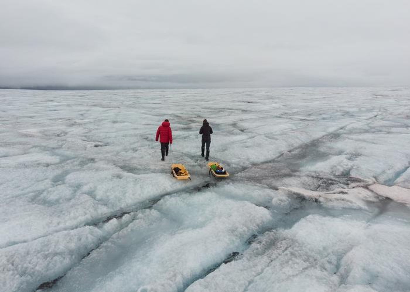 Laura Halbach and Rey Mourot set off to collect ice samples on the Greenland Ice Sheet. / Credit: Laura Halbach