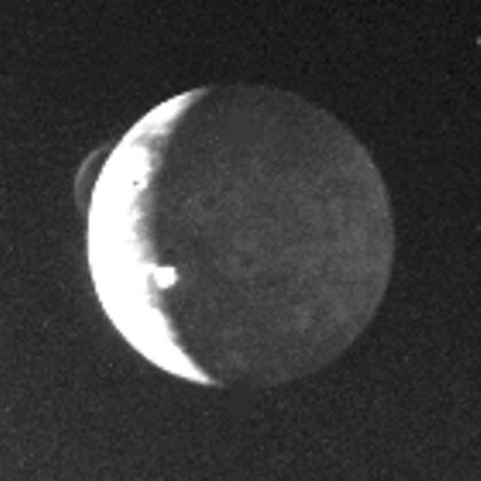 1977 Voyager 1 image of Io showing two active eruptive plumes (upper left and left of center). This historic photo was among the first to verify active volcanism on the moon. (Image Credit: NASA/NASA JPL)