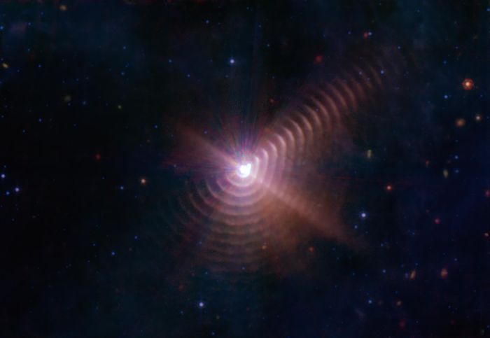 This image shows shells of dust created by the two stars in Wolf-Rayet 140. These rings are produced when the stars are close together in their orbits and their stellar winds collide. Credit: NASA/ESA/CSA/STScI/JPL-Caltech