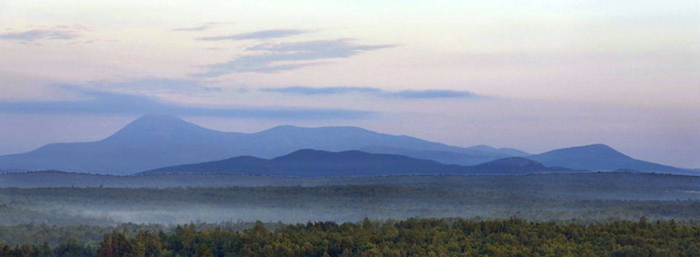 Early morning haze colors Mount Katahdin and its surrounding mountains as seen in 2014 from a height of land along Route 11 in Patten, Maine. The viewpoint is part of the Katahdin Woods & Waters scenic byway. Gregory Rec/Portland Press Herald via Getty Images