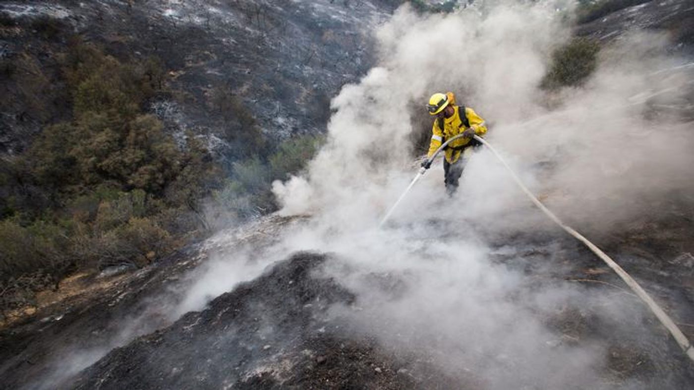 L.A. County firefighter fights the fire on Sunday. Photo: Allen J. Schaben / Los Angeles Times