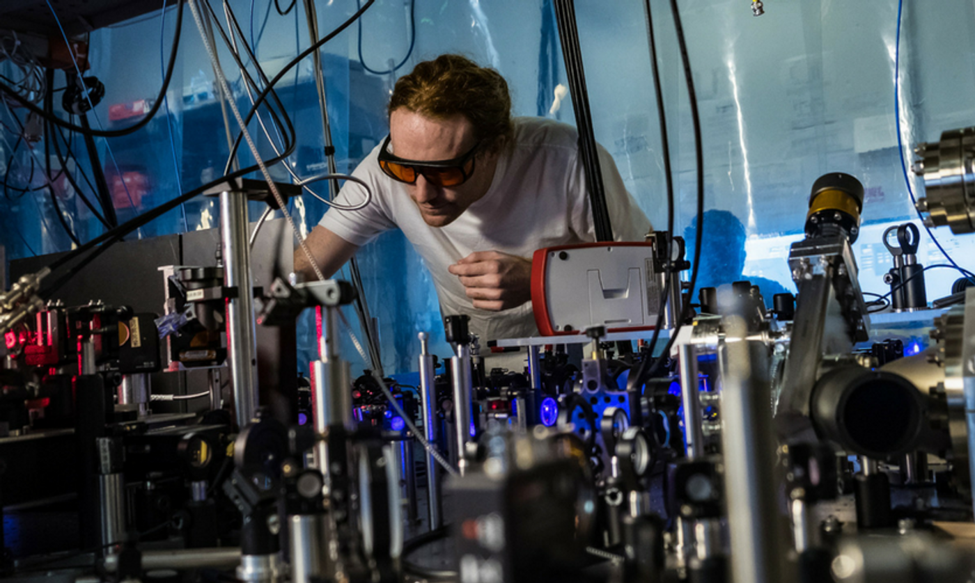 Rice physicist Joe Whalen and his laser cooling system. Credit: Jeff Fitlow/Rice University