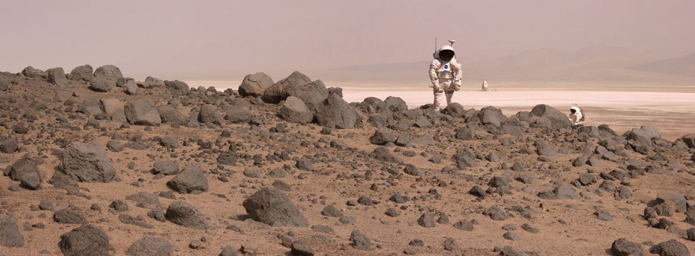 An artist's rendition of astronauts walking on the red planet.