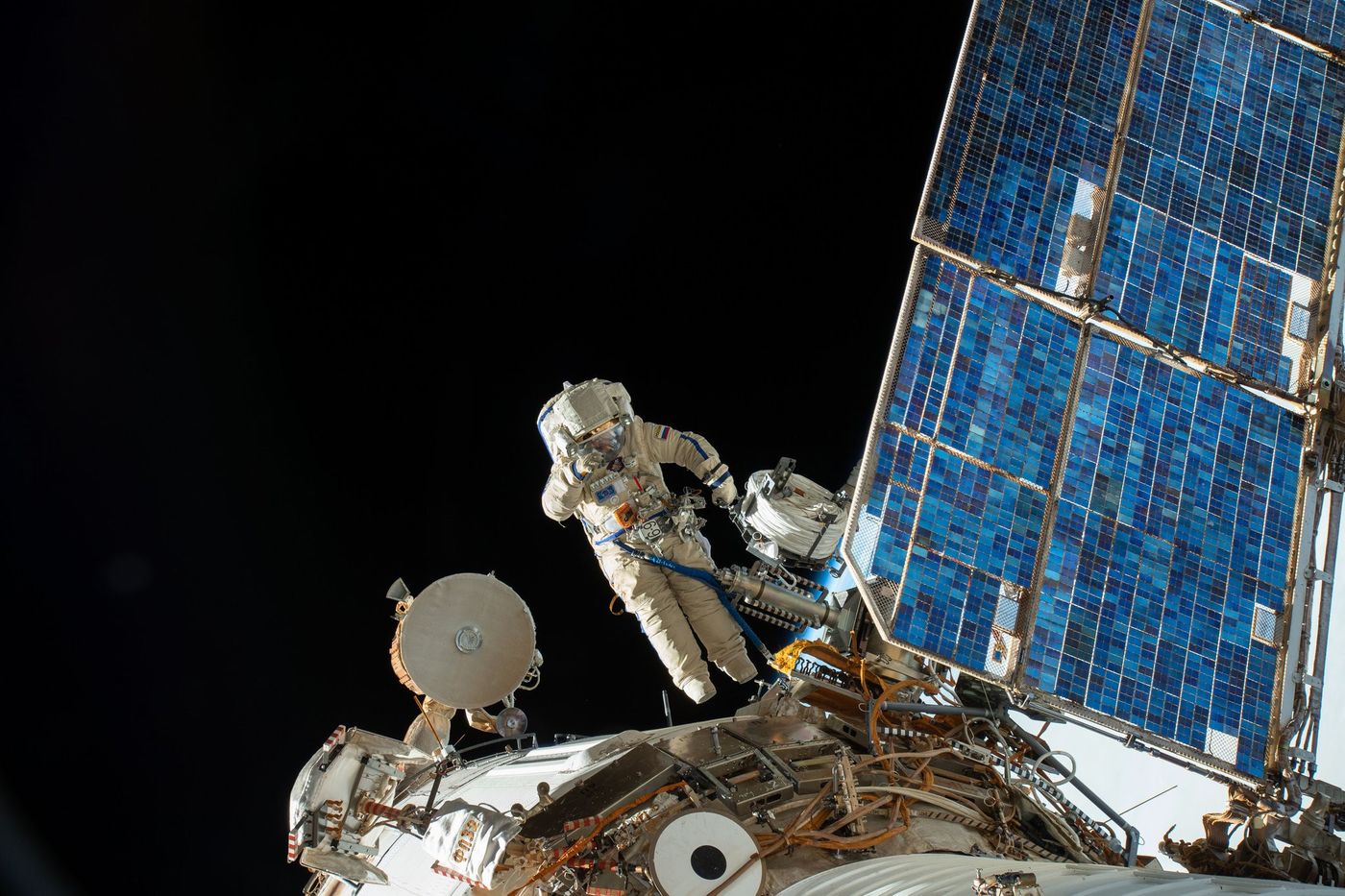 Two cosmonauts performed a spacewalk on Tuesday to study the site of the mysterious hole that caused an air leak in August.