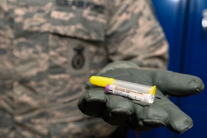 Staff Sergeant Matthew Pick, 66th Security Forces Squadron, holds a nasal applicator and naloxone medication vial, designed to temporarily reverse the effects of an opioid overdose Dec. 11 at Hanscom Air Force Base, Mass. Hanscom is the first U.S. Air Force installation to issue the drug to law enforcement personnel under permission of the base commander. / Credit: U.S. Air Force photo by Mark Herlihy