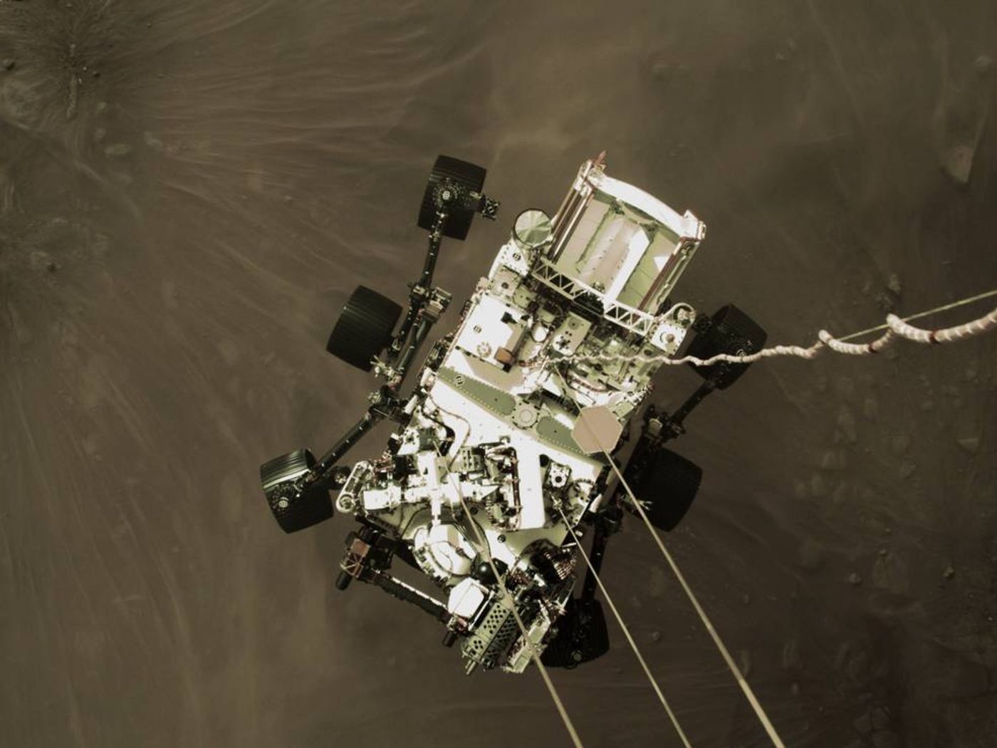 NASA's Perseverance Rover being lowered onto the Martian surface by its descent stage. Credit: NASA/JPL-Caltech