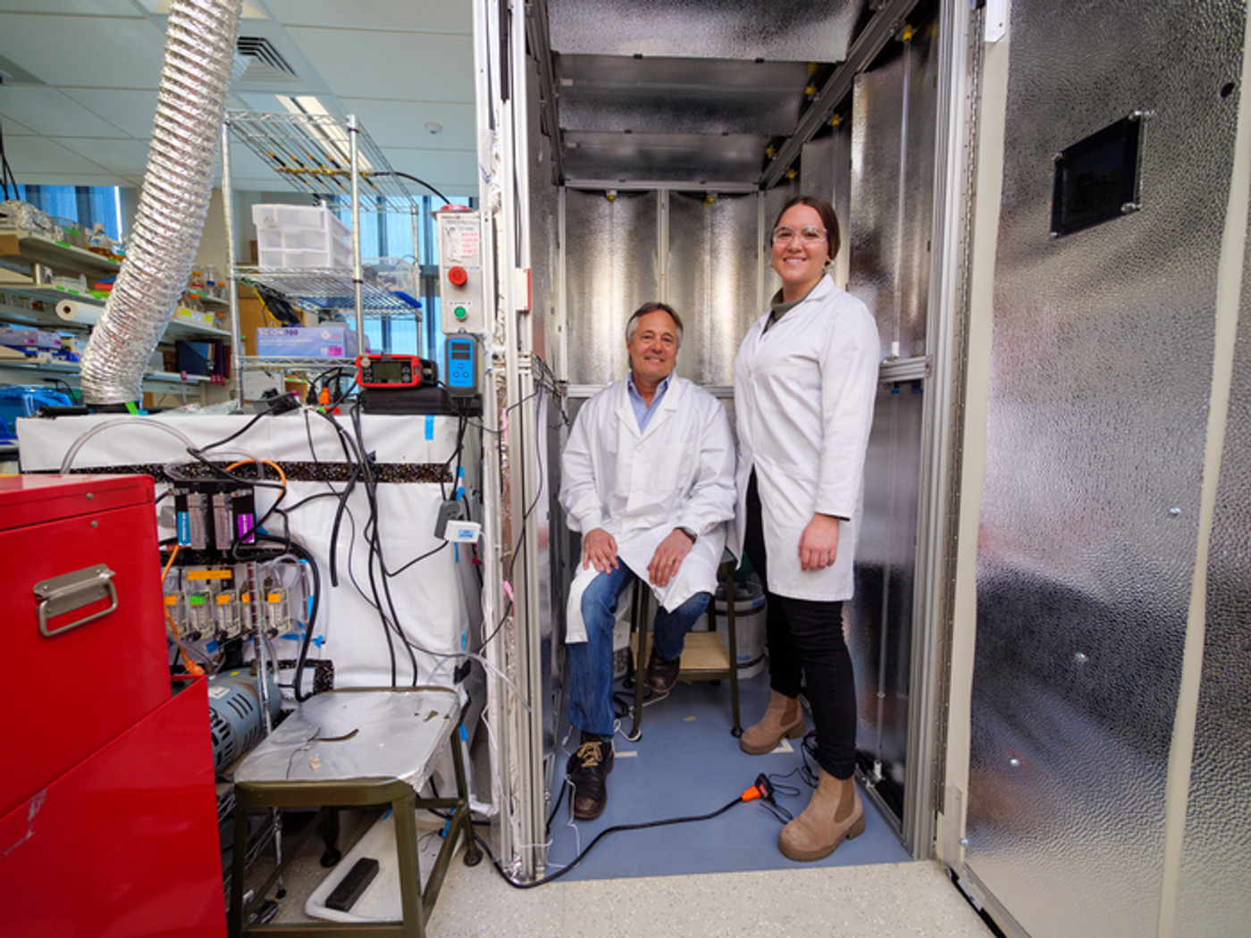 Dr. Mark Hernandez, S. J. Archuleta Professor of Civil and Environmental Engineering, and CU PhD graduate Marina Nieto-Caballero, now a postdoctoral researcher at Colorado State University, standing inside a bioaerosol chamber in the Environmental Engineering disinfection laboratory at the Sustainability, Energy and Environment Complex (SEEC). Credit  Patrick Campbell/University of Colorado