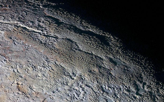 Pluto's surface shows signs of expansion.