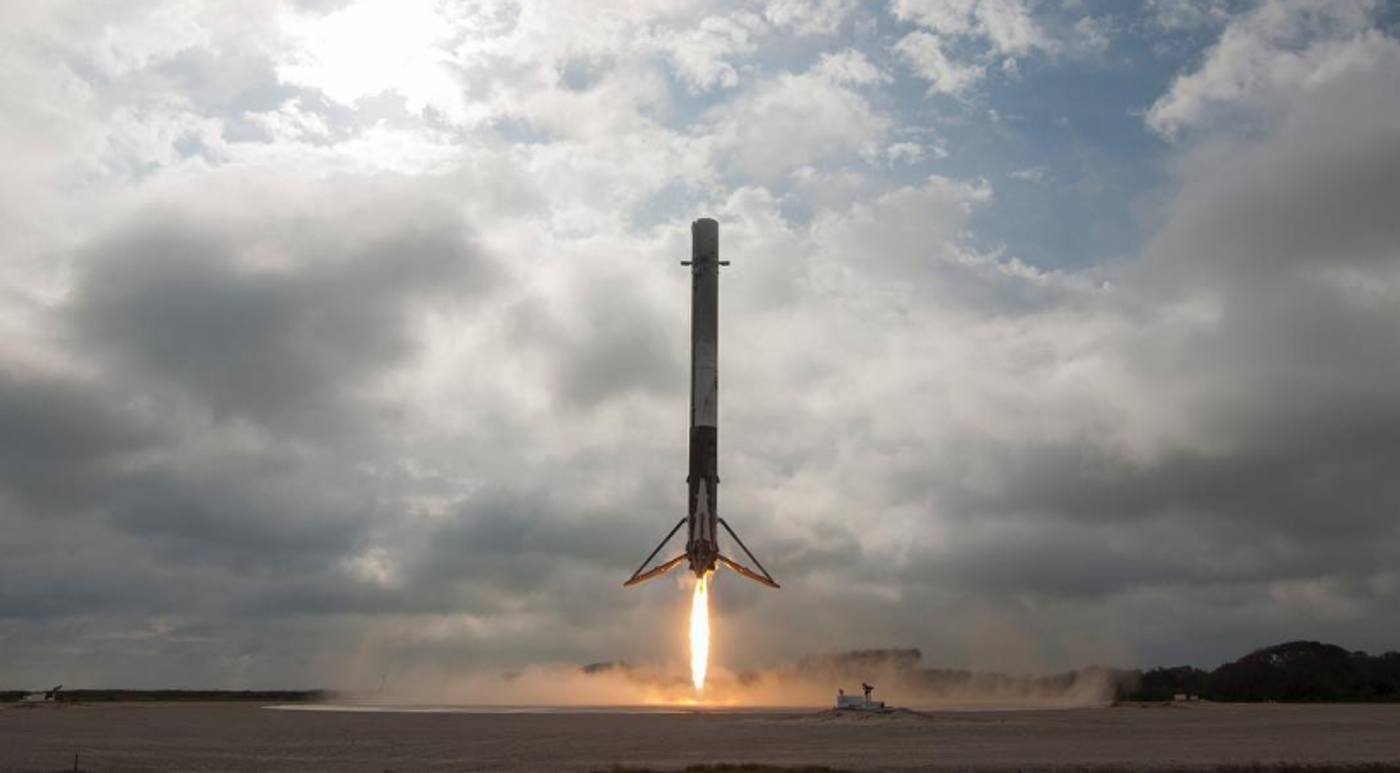 A SpaceX Falcon 9 rocket landing upright after flying to space.